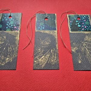3 black gift tags with metallic leaf imprint and botanic collage detail, with vintage linen thread