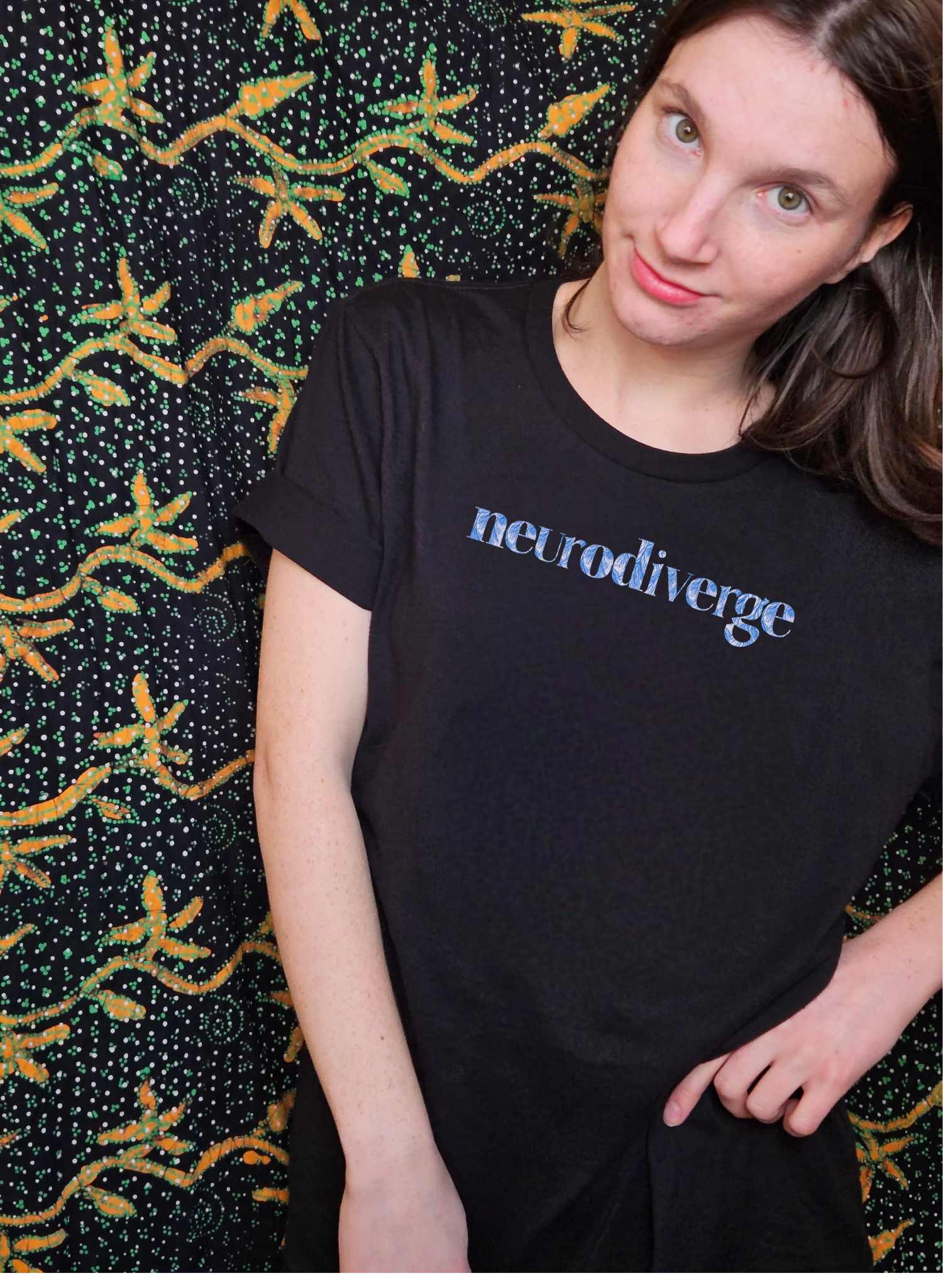 A young woman wears a black t-shirt with 'neurodiverge' lettering