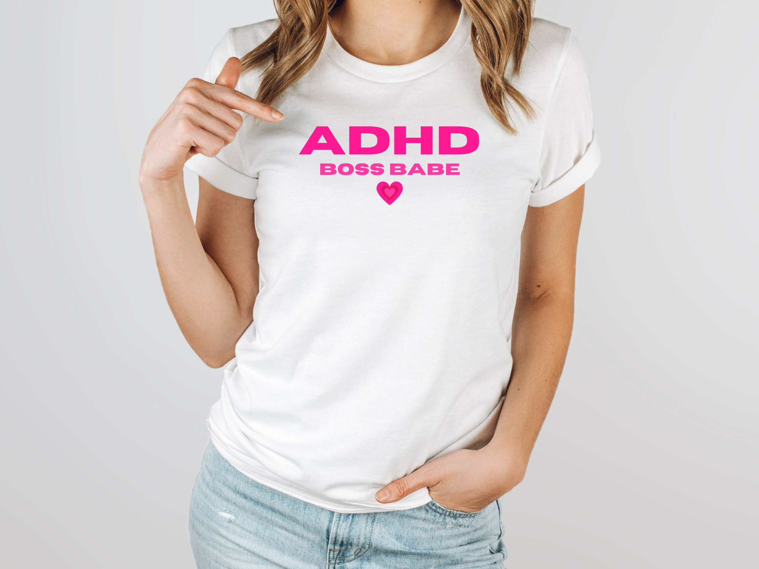 a white tshirt with ADHD boss babe in pink lettering with a pink heart